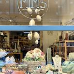 Vitrine Mim's décorée pour Pâques avec œufs suspendus, sacs et bijoux